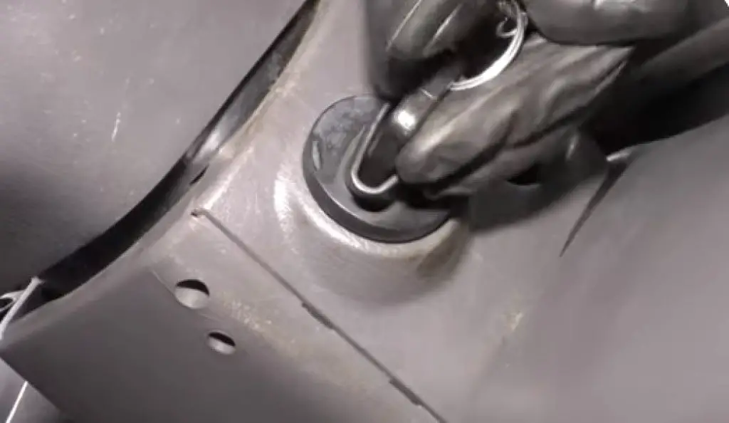 Close-up image of a hand turning the ignition key to the OFF position inside a Ford F-150