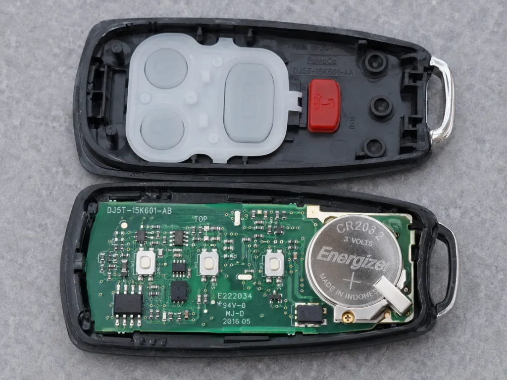 How to Change Battery in Ford Key Fob — Complete Guide 2026 (All Models) 3 Close-up of an open Ford key fob showing the PCB circuit board, rubber button membrane, and coin battery holder inside the casing.