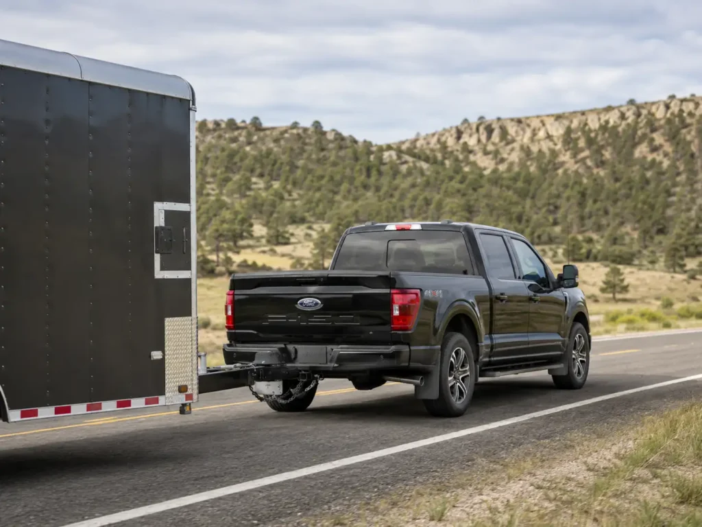 Ford F-150 Towing Capacity by Trim: Full Chart 2024-2026 2 2025 Ford F-150 SuperCrew towing trailer showing towing capacity by trim