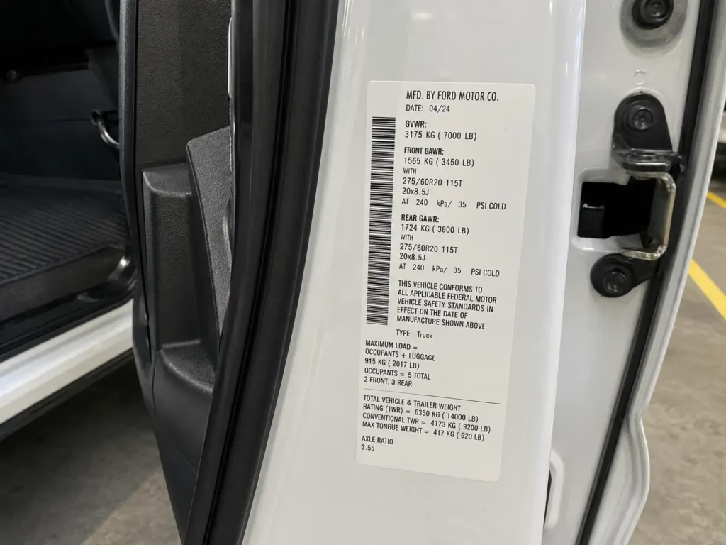 Ford F-150 Towing Capacity by Trim: Full Chart 2024-2026 3 Ford F-150 door jamb payload sticker showing axle ratio and GVWR for towing capacity verification