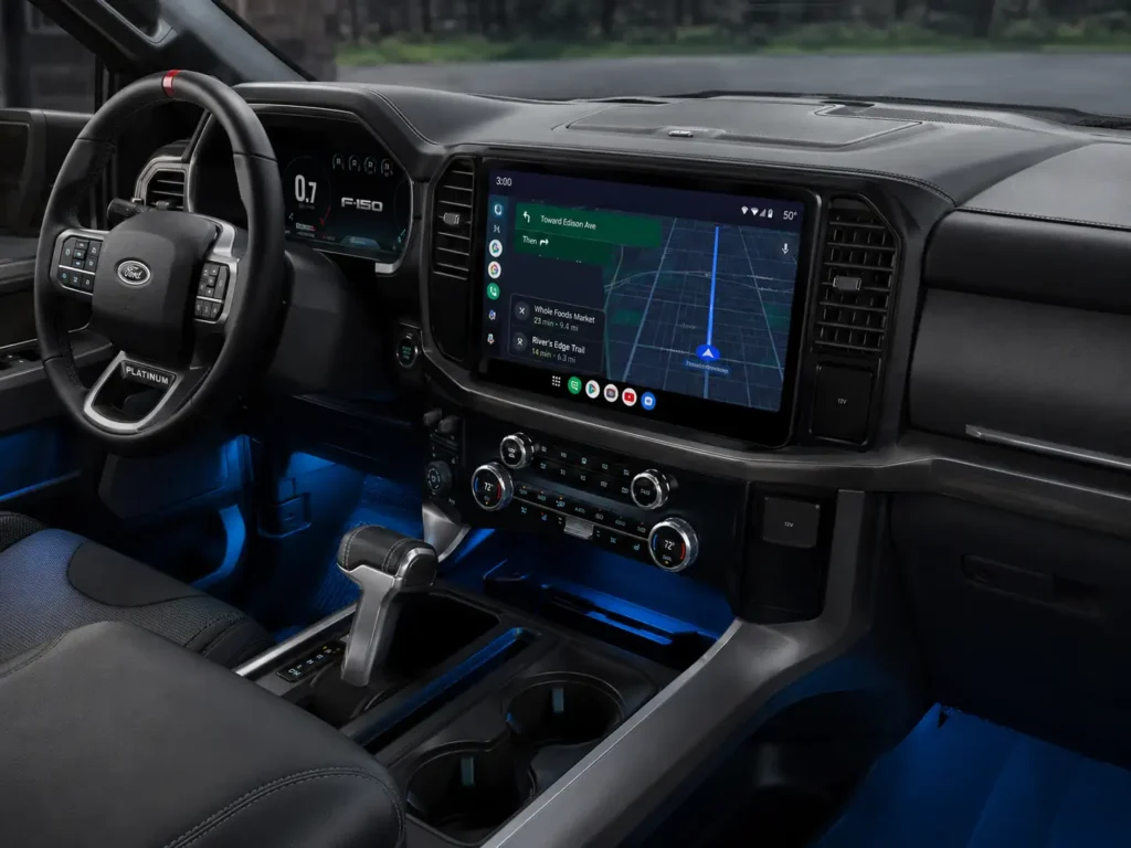How to Enable Ford SYNC Android Auto: 2026 Complete Guide 2 Modern Ford F-150 interior with a 12-inch infotainment screen displaying Android Auto and Google Maps, illuminated by soft blue ambient cabin lighting.
