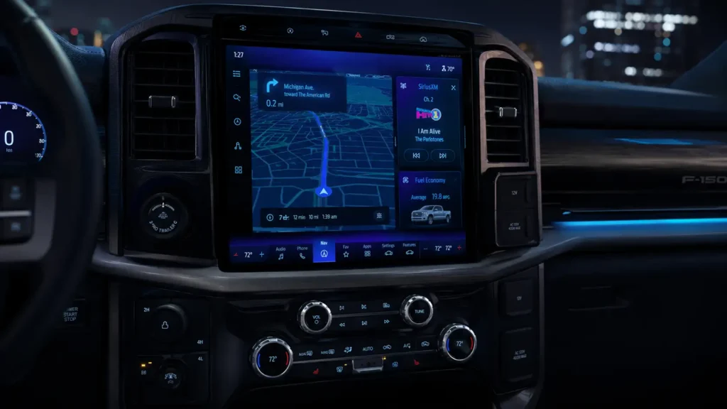 How to Calibrate Ford SYNC: APIM Diagnostics and System Reset Guide 2026 2 Modern Ford F-150 interior at night with a large glowing SYNC 4 touchscreen showing navigation, media, and vehicle data in a futuristic blue and purple interface.