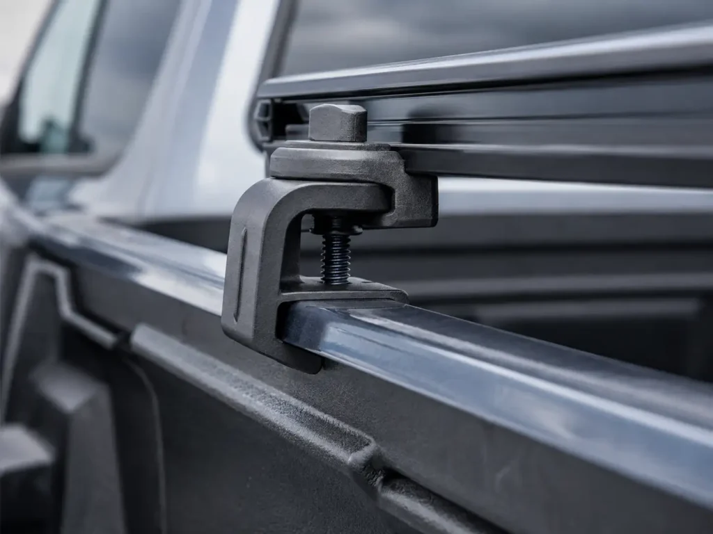 Close-up of Ford Maverick tonneau cover clamp attached to the interior bed rail