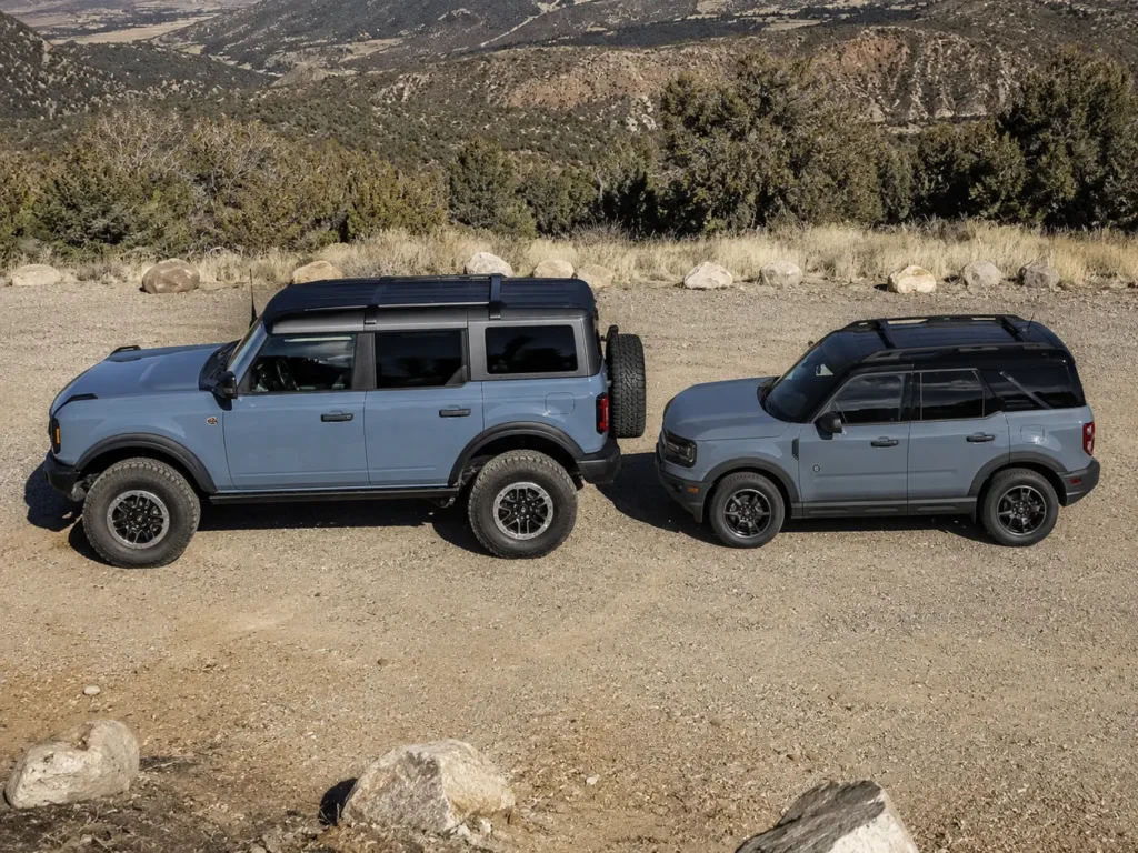 Full-size Ford Bronco and Bronco Sport parked side by side showing size difference
