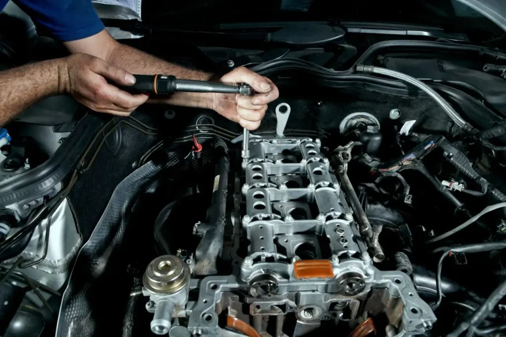 Torque-angle tool beside Ford Edge 2.7 EcoBoost VCT engine components.